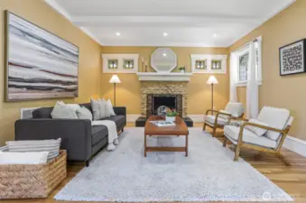 Inviting living room centered around a cozy wood-burning fireplace, framed by beautiful stained-glass windows that add timeless charm.