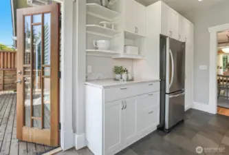 The kitchen opens effortlessly to the deck, perfect for indoor-outdoor living.