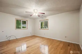 Hardwood floors carry thru the primary bedroom.