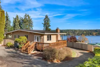 Perched slightly above the homes on Illahee Road, so all the view and none of the traffic. Room to park above or below.
