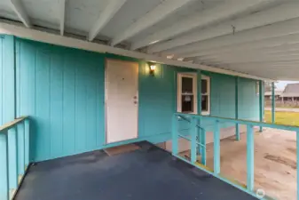 Paved carport and covered front porch keeps you out of the weather upon arriving home.