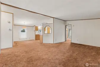 View from the front door. Great flow to the living spaces. Primary suite through the door to the right.