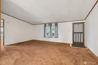 Looking back at the front door, the living room provides ample space and versatility for furniture placement.