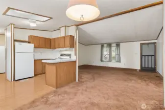 View from dining room, with kitchen to the left and living room straight ahead. 2 bedrooms and a full bath are to the right of this view.