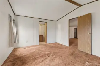 Looking back from closet towards bathroom in primary bedroom.