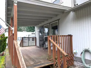 Covered front deck with access to driveway, RV parking & interior.