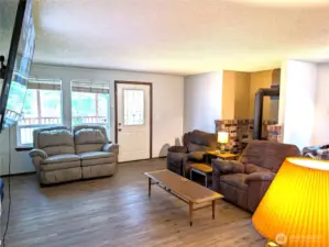 Entry w/laminate flooring & gas fireplace in family room.
