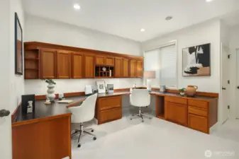 The main-floor den features beautifully crafted custom built-ins, creating a refined work-from-home space, with the flexibility to serve as a guest room if desired. A connected 3/4 bath enhances the functionality of the main level for visitors or extended stays.