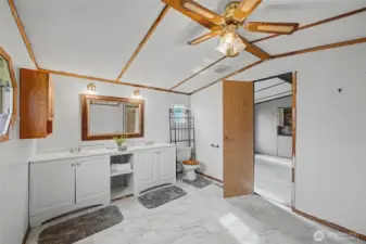 Large ensuite bathroom with 2 sinks, a tub and a separate shower.