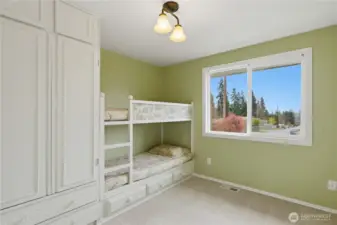 Flexible bedroom with built-in bunkbeds and closet space.