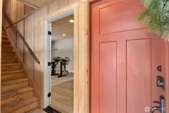 Entryway leading you to the upstairs, downstairs bedroom and interior garage access.