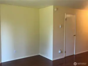 Living room leads to the entry hallway and the 1/2 bath behind the door.