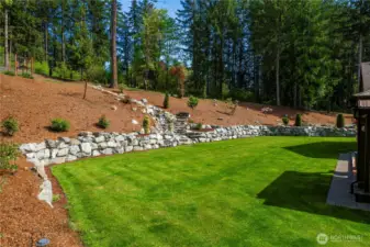 Sideyard between outdoor kitchen and waterfall.