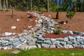 Rock stairway follows contour of waterfall.