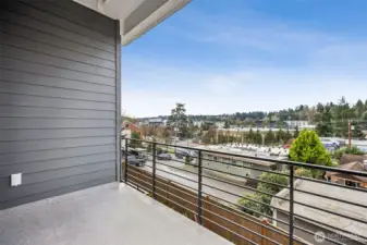Large covered patio off of living space with expansive views of sunsets, territorial and partial downtown views.