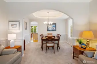 From the living room looking into the dining room, and the large kitchen is beyond. Lots of light from the windows. Must see this design to really appreciate the layout.
