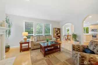 Informal great room with windows and private living off huge kitchen and eating area dinette. Door to back yard and large deck is too.