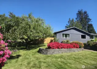 Gorgeous property with mature plantings, flowers, fruit trees & sprawling property.
