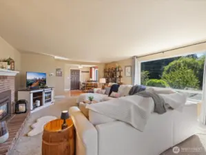 Spacious Living Room with propane Fireplace & walls of view windows.