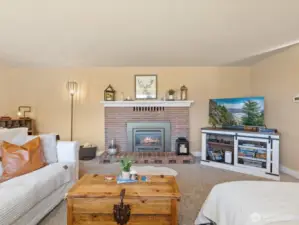Spacious Living Room with propane Fireplace & walls of view windows.
