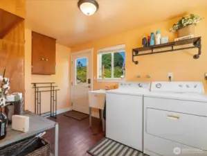 Large Laundry Room with door out to the Patio & Backyard.