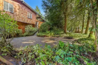 Large brick paver patio space in front of the home.