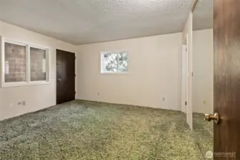 Primary bedroom upstairs with door to private covered balcony.