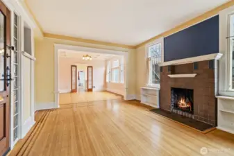 Spacious living room with Art Deco tilework and built-ins framing a cozy fireplace.