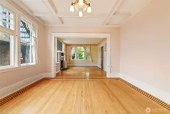 Elegant coffered ceilings, ribbon inlaid hardwood floors, and a graceful flow between living and dining spaces.