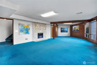 And downstairs to the rec room w/ cozy fireplace