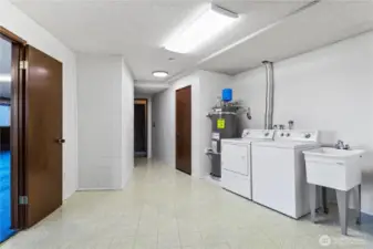 HUGE laundry room with plenty of storage space & utility sink