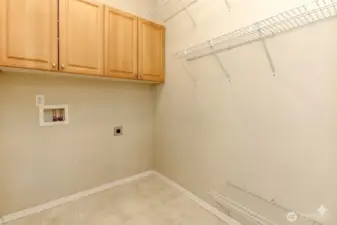 Laundry room w/cabinetry & shelving