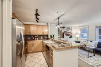 Kitchen with granite counters, stainless steel appliances, and eating bar.