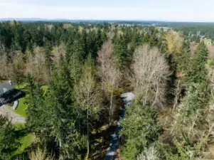 Great overhead shot of the access road. Property sits behind home on left.