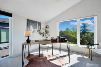High-ceiling guest bedroom located on the third level offers comfort and space for visitors or a home office.