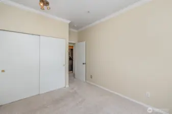 Spacious guest bedroom featuring a sliding door closet for convenient storage and a welcoming retreat for visitors.