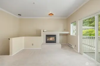 Living room with sliding glass doors that open up to a private balcony, bringing in fresh air and natural light.