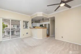 From this angle, the open-concept design seamlessly connects the living room and kitchen, creating a warm and welcoming space for gatherings.