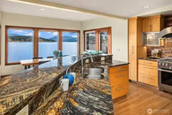 All of the elements of a gourmet kitchen you'd want:  slab granite counters and bar, Sub-Zero refrigerator, Meile range, hard wood cabinets etc.