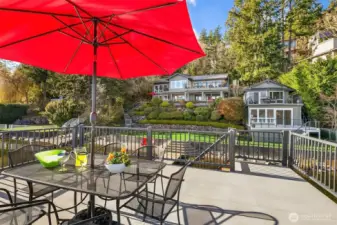 Top of the double decker dock with views of the lake, sandy beach, 100' of waterfront, sunny lot, main house and charming beach cottage with its own decks!