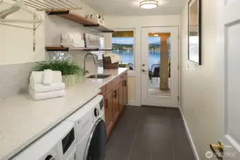 Huge laundry room with loads of storage and access to outside.
