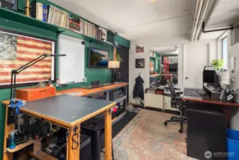 Tucked away for privacy, the dedicated home office offers a quiet workspace with ample natural light, ideal for remote work, studying, or creative projects—complete with space for a full desk, storage, and seating.
