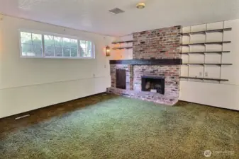 Spacious recreation room with gas plumbed fireplace.