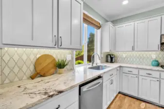 Artisan backsplash compliments the granite counters.