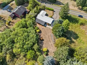 From above, the 1.36-acre corner lot shows its range with wooded areas near the house for privacy, long open backyard space for gardens, and easy access out to Puget Road. It’s land that feels tucked away but still connected.