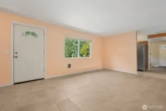 Up close, the front entry shows off its arched glass door and large picture window, while the wall to the right keeps the kitchen fridge and storage zone tucked away. Call it the pantry side, or just a smart way to keep the workhorse part of the kitchen from stealing the spotlight.