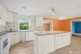 Square white tile is a classic move, but here it’s done right, running floor-to-ceiling so the kitchen feels finished. The glass-topped electric stove adds to the clean lines, and you skip the natural gas debate entirely. It’s simple, safe, and polished.