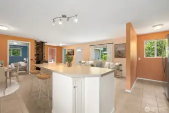 The island gets practical with a rotating corner cabinet and bar seating that faces the living room, not the stove. It makes conversation easy, whether you’re hosting or just trying to keep an eye on things. The side wall is finished in tile to handle scuffed shoes from stools, proving durability can still look polished.