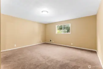 At roughly 15'x15', this bedroom gives you real square footage to work with. Mirrored closet doors double as full-length fit check central or your own dance studio. The tan walls keep it light, while warm latte carpeting makes the room feel grounded.