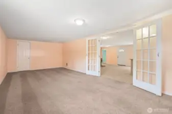 This angle shows the closet and the French doors with glass panels, a combo that makes the room feel complete. Close the doors and you get a solid sound barrier from kitchen clatter, while the carpet softens noise inside. Perfect setup for a media room or the third bedroom you’ve needed.